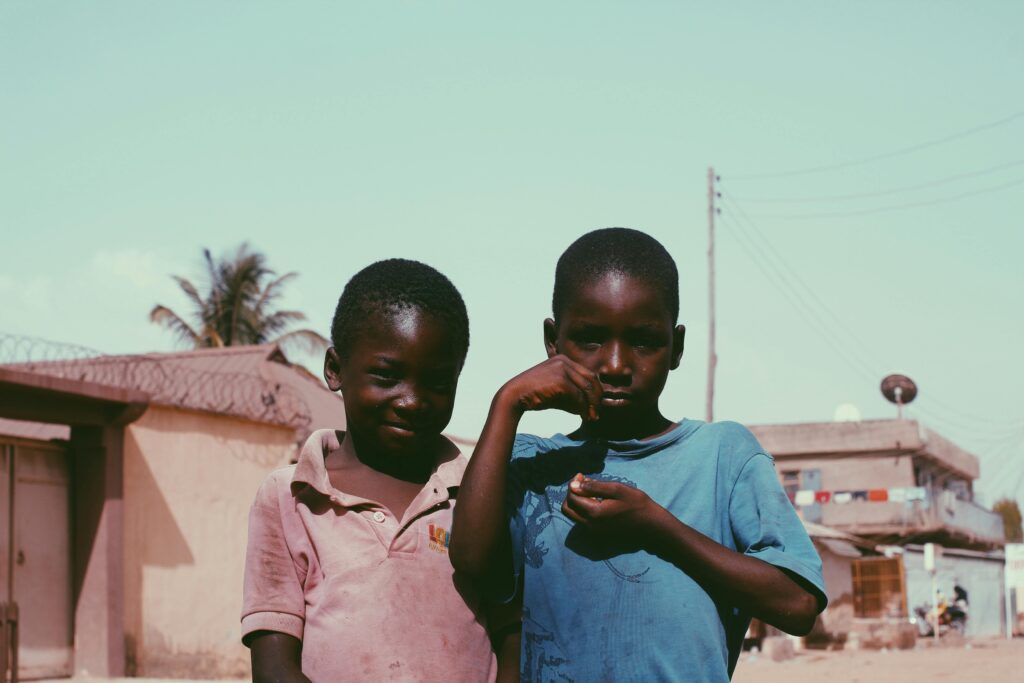 Two Boys Standing Next to Each Other